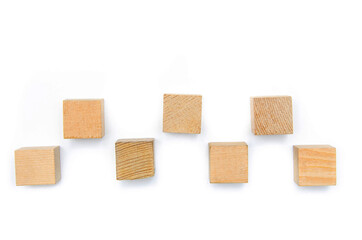 Wooden cubes on a white background. Seven identical cubes lie in a checkerboard pattern, a taxi driver’s checker