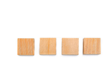 Wooden cubes on a white background. Four identical cubes lie, stand in a row together and separately, directly and at an angle. Place for text
