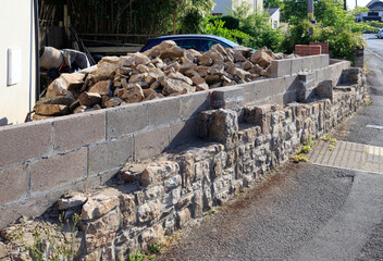 Natural stone wall construction. Built next to a breeze block wall for structural support