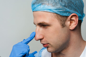 Facebuilding. Septoplasty and nose rhinoplasty. Doctor touches man nose on consultation. Inspection...