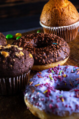 Donuts on a wooden board on a blue concrete background
