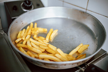 Close-up of fries in metal pan in the restaurant