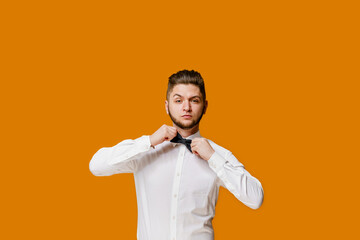 Confident business man touches and correct butterfly. Famous caucasian man smiles and stays over...