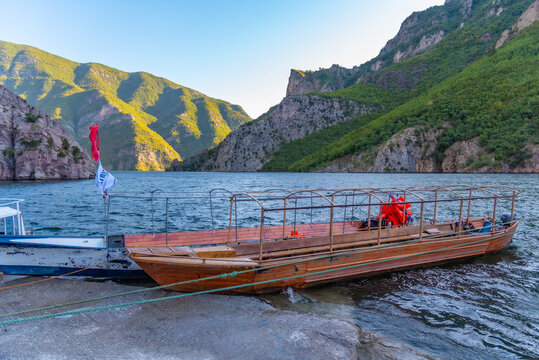 Wooden boats mooring at Komani ferry pier in Albania
