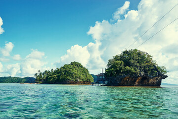 Beautiful landscape with blue sea, tropical islands and fishing houses on stilts in mangrove lagoon, Siargao Island, Philippines.