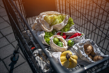 set of reusable and zero waste cotton shopping bags for food in cart