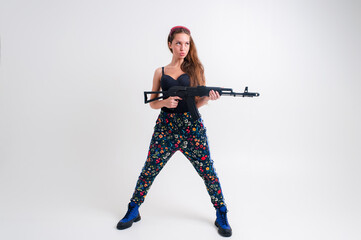 Strong young woman with a gun, picture isolated on white background