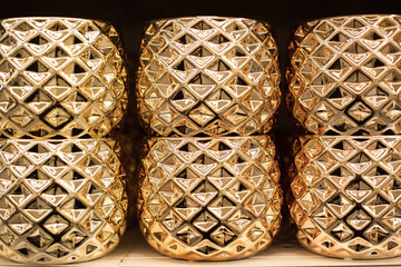 gold pots in a row. ceramic. close up. background
