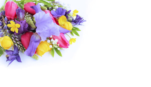Bright spring flower arrangement. Lilac Alstroemeria and Aquilegia, as well as yellow flowers of trolius europaeus and crimson tulips on a white background. Bright light colors. Background for spring 