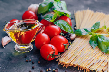 Ingredients for traditional Italian pasta spaghetti, tomatoes, basil and olive oil.