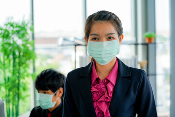 Business woman was sick from flu in the office and the male employee offer the protective face mask safety fro COVID-19 virus pandemic