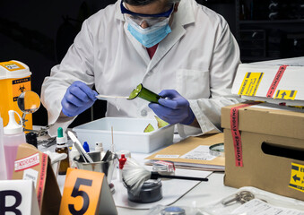 Police expert gets blood sample from glass bottle in Criminalistic Lab