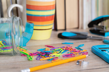 Office accessories necessary for learning. The paper clips are on the desk. School materials.