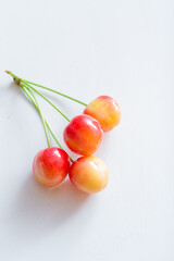 Sweet cherry berries on a white paper background isolate