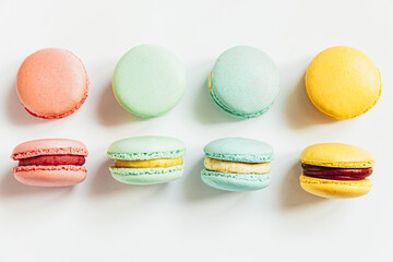 Sweet almond colorful pastel pink blue yellow green macaron or macaroon dessert cake isolated on white background. French sweet cookie. Minimal food bakery concept. Flat lay top view, copy space