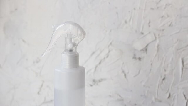 Feamale hand yousing Antibacterial spray bottle. Cleaning and sanitizing surface close up. Prevent spreading coronavirus