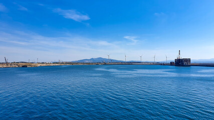 Fototapeta na wymiar Windmills on the sea, panoramic view banner. Concept of technology and green energy