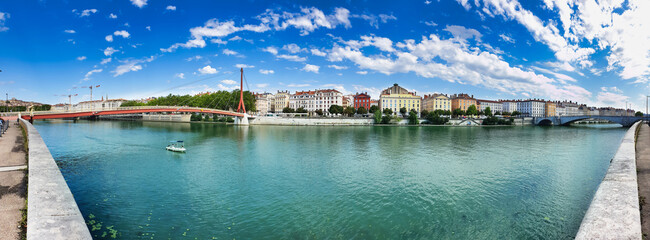 Fototapeta na wymiar Panoramic view on the red bridge Passerelle du Palais de Justice of Lyon and river embankment, travel and tourism concept