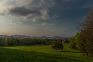Color sunset with fresh meadows and old buidlings near Trojanovice village