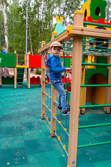 boy playing on the playground on a nice day