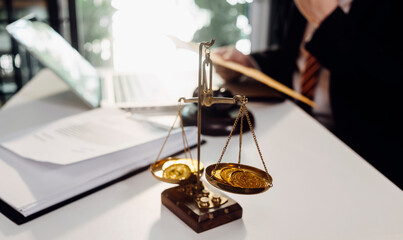 Justice and law concept.Male judge in a courtroom with the gavel, working with, computer and docking keyboard, eyeglasses, on table in morning light
