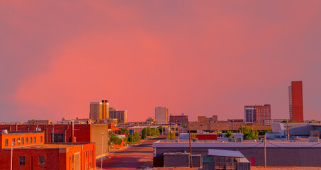 A brilliant sunset colors downtown Lubbock, Texas, including the streets and buildings.