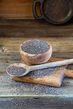 Chia seeds in wooden bowl on wooden background 