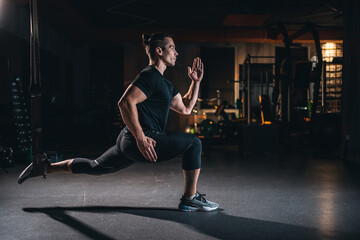 young man has crossfit workout with roller and weight in gym