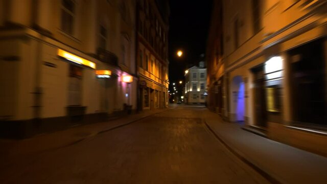 4K - Fast motion through the old European city at night. timelapse