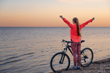 A girl stands with a bicycle © ivan