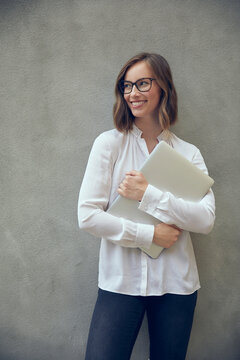 Portait Of Beautiful Business Woman Holding Her Laptop Smiling