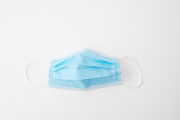 Blue surgical face mask on white background