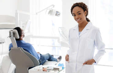 Pretty african woman dentist in dental clinic