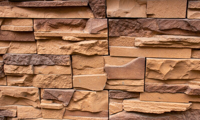 Stone facing of facades and walls.The wall is made of decorative facing stone, such as Sandstone or slate. The texture of the stone