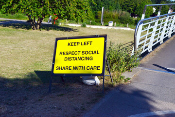 Social Distancing Sign at the start of the millennium bridge in York, UK