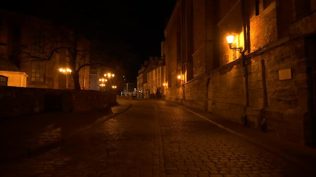 4K - Camera slowly moves through the old European city at night
