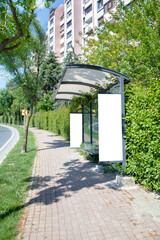 advertising board at bus stop on asphalt road