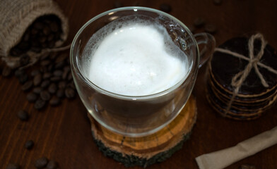 Glass cup in the shape of a heart and double glass. Cappuccino and chocolate cookies. 
