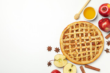 Composition with tasty apple pie on white background, top view