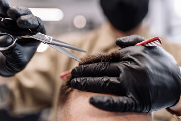 Men's haircut in a barbershop. Styling and hair care. 