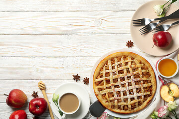 Composition with apple pie and ingredients on wooden background, top view