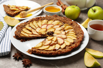 Composition with apple pie and ingredients on gray background. Homemade food