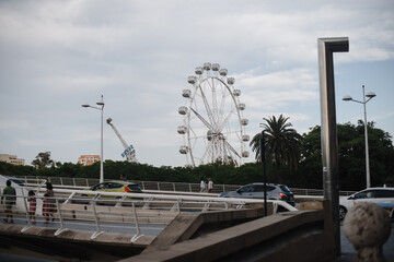 Ferris wheel, sky, clouds, amusement Park. Photoraphy of the big Ferris wheel against the blue sky