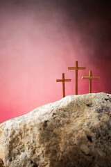 Crucifixion, resurrection of Jesus Christ. Three crosses against red sky on Calvary hill...