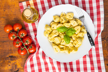 Tortellini pasta. Italian stuffed pasta with basil leaves.