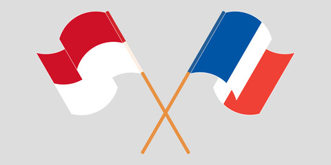 Crossed and waving flags of Indonesia and France