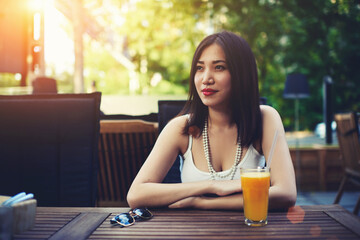 Stylish female refuses to take the picture while sitting in coffee shop