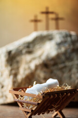 Obraz premium Wooden manger, three crosses background. Jesus - reason for season. Christian Christmas, Easter concept. Born to Die, Born to Rise. Salvation, Messiah, Emmanuel, God with us. Chronology of Jesus life