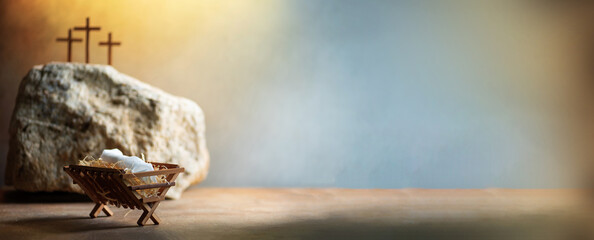 Christian Christmas, Easter concept. Born to Die, Born to Rise. Wooden manger, three crosses...