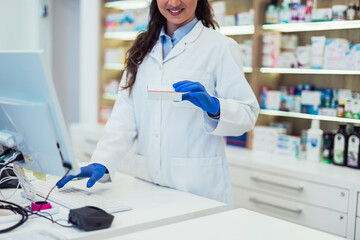 Female pharmacist working at pharmacy. Medical healthcare concept.